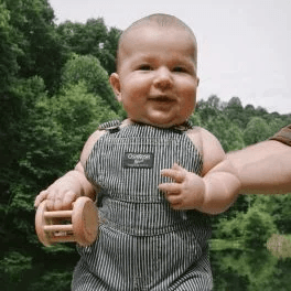 Child holding the Rolling Bell from The Charmer Play Kit