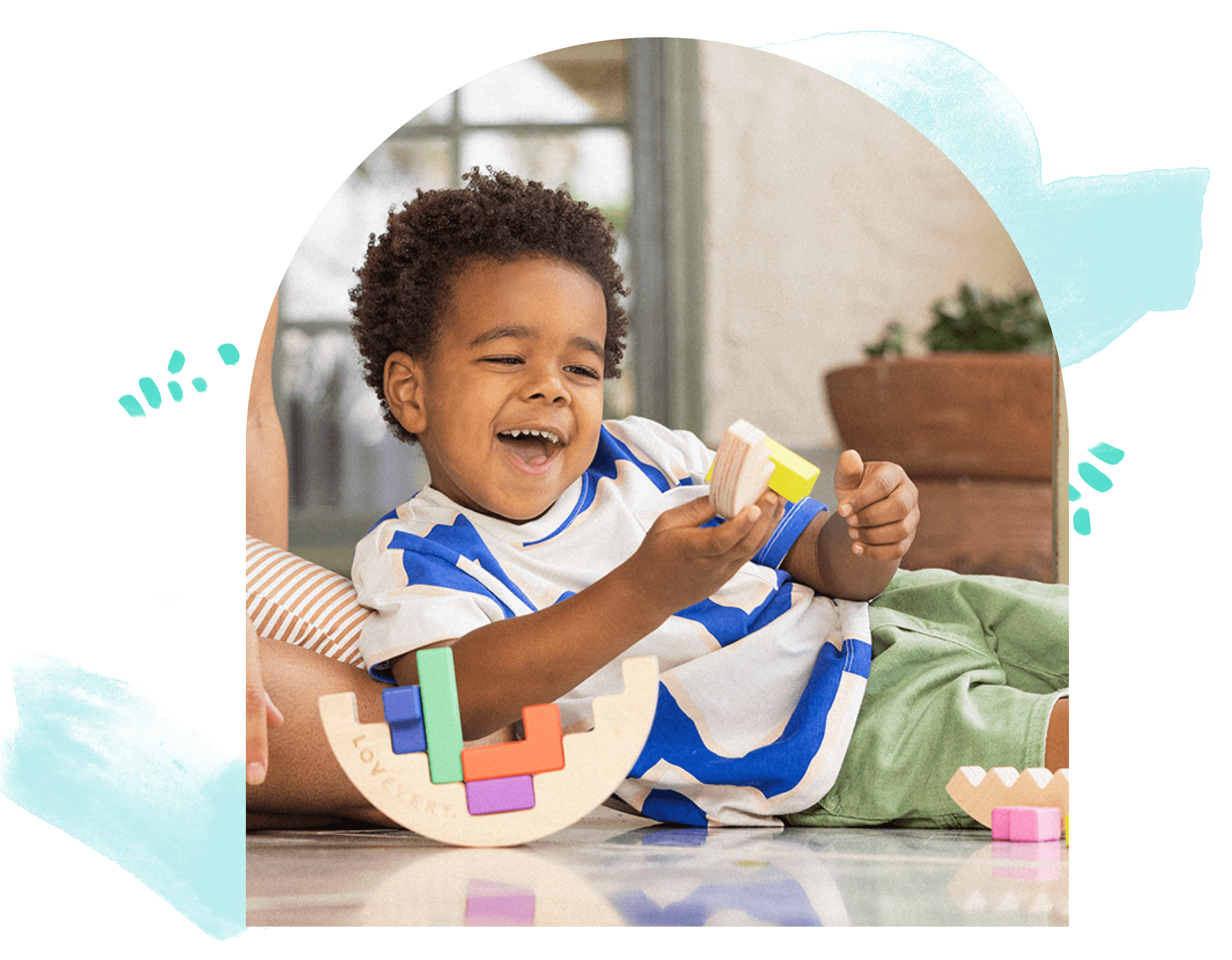 Little boy playing with the Wooden Wobble Puzzle from The Problem Solver Play Kit